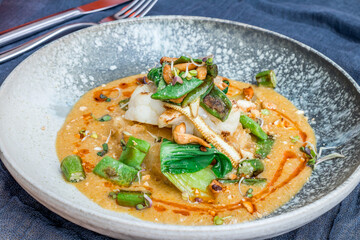 fried tofu on plate with carry sauce side view