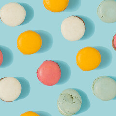 Pastel blue table top with colorful macarons pattern. Minimal sweet food concept. Cookie concept.