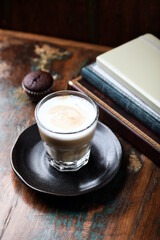 Coffee with milk on rustic wooden background. Soft focus.