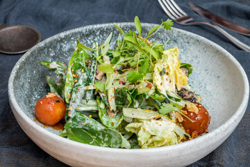 Green vegetable salad with tomatoes and vegetables side view macro close up