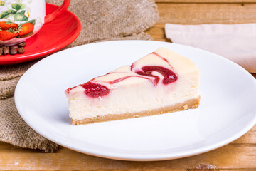 strawberry cheesecake on a white plate macro close up