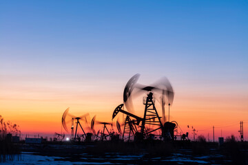 In the evening, oil pumps are running, Silhouette of beam pumping unit