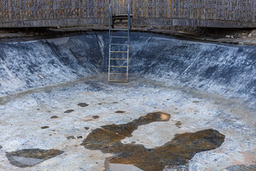 the space of an empty old pool with a staircase descending into it