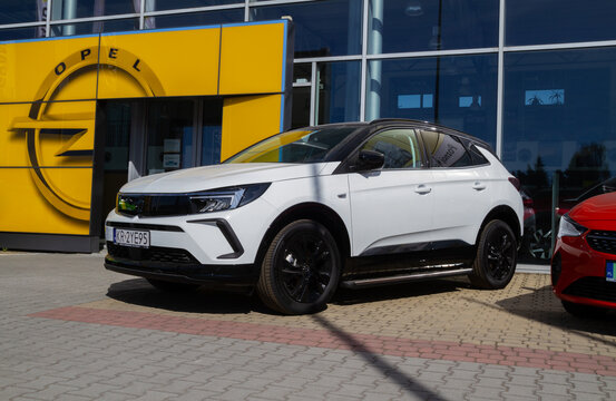 Opel Grandland, compact crossover SUV car in front of dealership building. German manufacturer auto salon with logo sign. Showroom with corporation brand logotype on March 27, 2022 in Krakow, Poland.