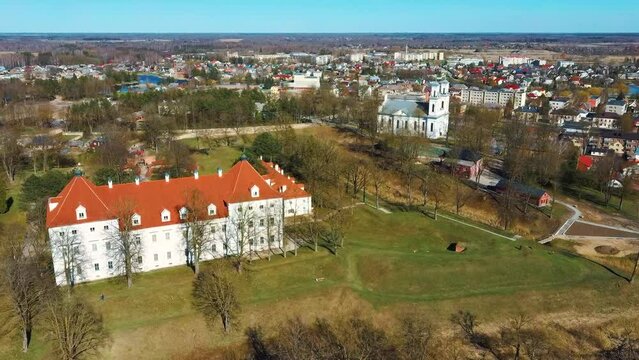 Aerial Shot of Birzai Castle, Fortress Birzai - a Castle in Birzai, on the Southern Coast of the Lake &Scaron;irvėna in Lithuania, Sunny Spring Day. Historic Beautiful Church and Birzai City Panorama 4K UHD 