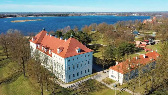 Aerial Shot of Birzai Castle, Fortress Birzai - a Castle in Birzai, on the Southern Coast of the Lake &Scaron;irvėna in Lithuania, Sunny Spring Day. Historic Beautiful Church and Birzai City Panorama 4K UHD 