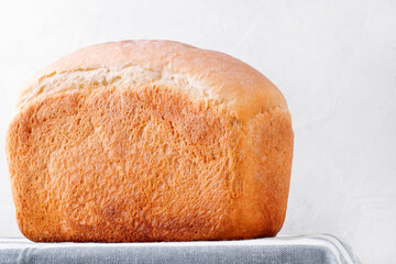 Big loaf of wheat bread on the kitchen table