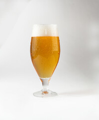 Glass with light beer. On a light background.