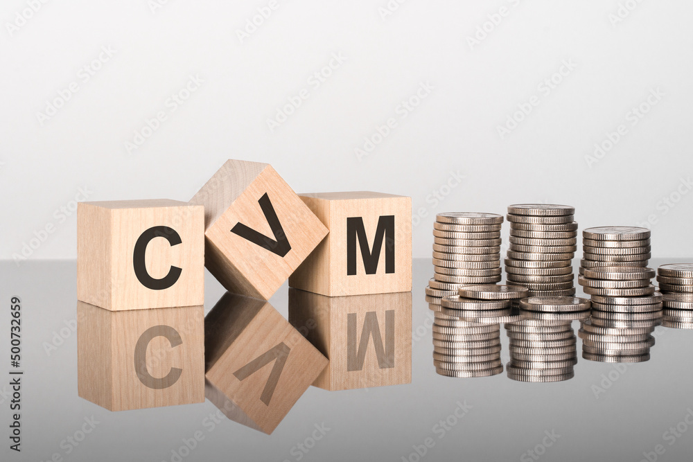 Poster cvm - the text is made up of letters on wooden cubes lying on a mirror surface