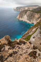 Fototapeta na wymiar Famous cliff rock, sea, celar blue water, nature in Zakynthos Ionian island, Greece. Amazing view with multicolored clouds, clear sky. Island of lovers. Doors to heaven.
