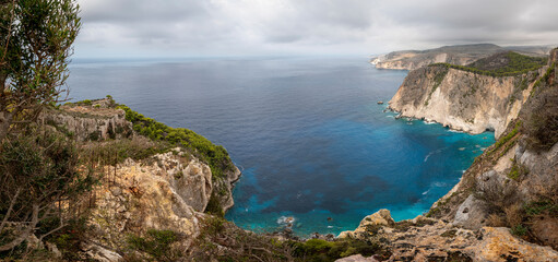 Fototapeta premium Famous cliff rock, sea, celar blue water, nature in Zakynthos Ionian island, Greece. Amazing view with multicolored clouds, clear sky. Island of lovers. Doors to heaven.