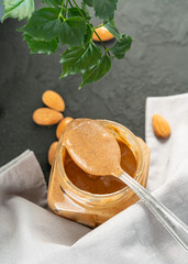 A jar of almond paste on a dark background top view