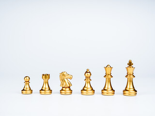 Set of luxury golden chess pieces isolated on white background. The photo of gold chess, king,...