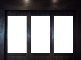 Three mockup vertical rectangle painting frames hanging on dark wood wall background with copy...