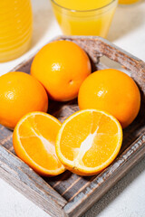 fresh oranges on a wooden tray, vertical top view