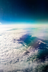 View form the airplane window on the mountains with rainbow glow