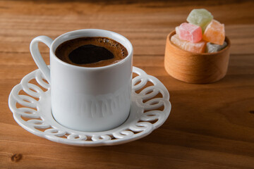 Traditional Turkish delight and Turkish coffee on a wooden background