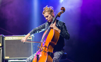 Young woman playing cello on the concert at night © Solid photos