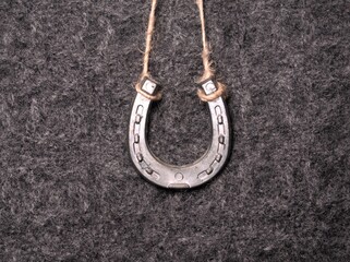 Good luck horseshoe on a gray background. Key ring in the shape of a horseshoe