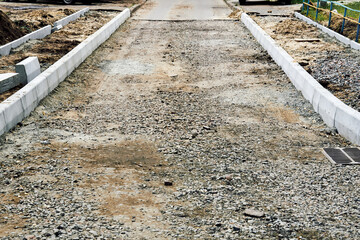Roadbed with crushed stone gravel prepared for asphalt laying