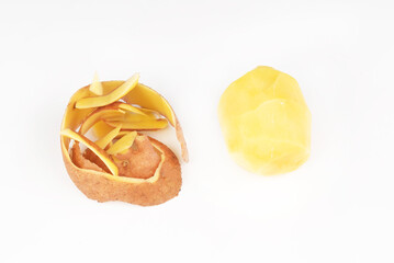 Peeled potatoes and peel on a white background.carbohydrate food.