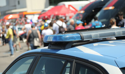 police car with flashing lights on it during the escort and demonstration with many people