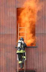 firefighter in action in the fire station with self-contained breathing apparatus and oxygen...