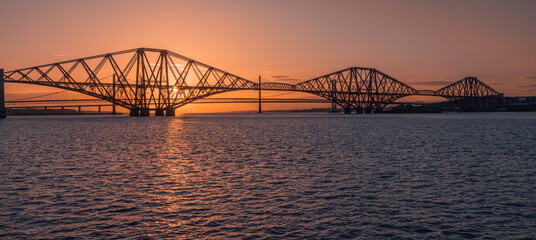 The Forth Bridge in Scotland at sunset.