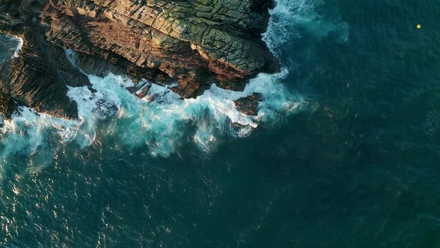 Aerial view of waves crashing on the rocks along the coast, Cornwall, United Kingdom.