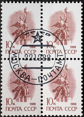 SOVIET UNION, USSR - CIRCA 1988: a postage stamp from SOVIET UNION, USSR , showing man and woman with arms raised Worker and Collective Farmer with hammer in hand . Circa 1988