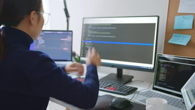 Timelapse young Asian woman, developer programmer, software engineer, IT support, wearing glasses working on computer to check coding in bugging system. Back view
