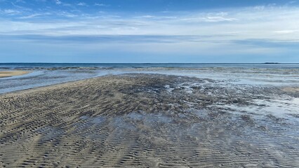 Sand Flats at low tide reflecting a soft blue sky along Long Island Sound