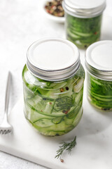 Conservation. Pickled cucumbers. Slices of Marinated cucumbers in glass jars. Homemade fermented cucumbers
