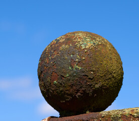 Old rusty iron ball fence ornament