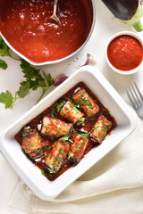 Baked eggplant rolls with tomato sauce and cheese