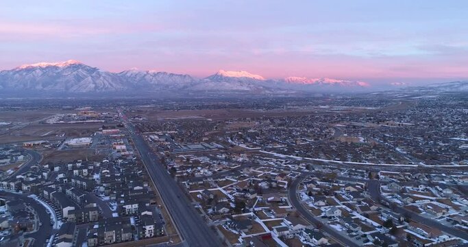Salt Lake City Valley and Wasatch Mountains at sunset with snowy mountains