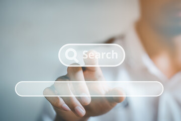 The man presses the search button on virtual screen, with a space to enter the search text..