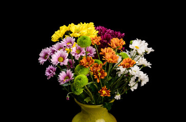 flowers in a vase on a black background