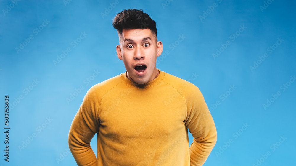 Aufkleber man looking at camera with a shocked expression on his face while standing over an isolated backgrou