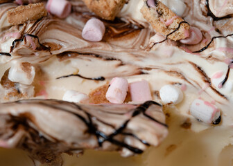 close up of vanilla ice cream with marshmellow in a box on the counter in the cafe