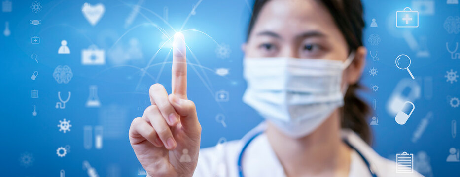 Medical healthcare Asian female doctor touching interacting technology futuristic holographic, surgical protective face mask, information diagnosing patient health stethoscope blue isolated background