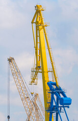 old port crane on background sky