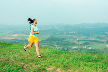 Asian trail runners, women  wearing sportswear are practicing on a high mountain running. During the evening when the air is fresh atmosphere is good.