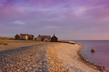 Small fishing village Helgumannen on the coast of the island of Faroe near Gotland in the early morning light