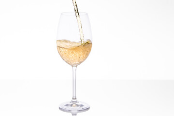 Glass being filled with bubbly white wine
