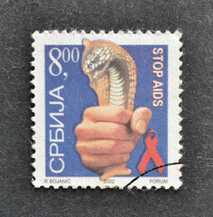 Cancelled postage stamp printed by Serbia, that promotes Fight against AIDS, circa 2002.