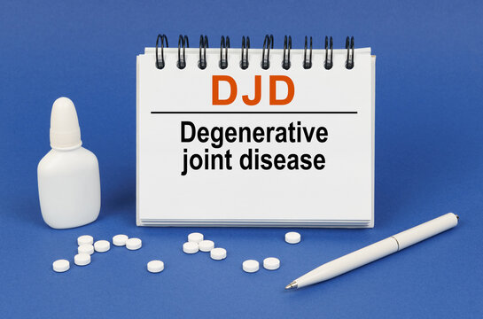 On a blue background, a pen, tablets and a notepad with the inscription - DJD Degenerative joint disease