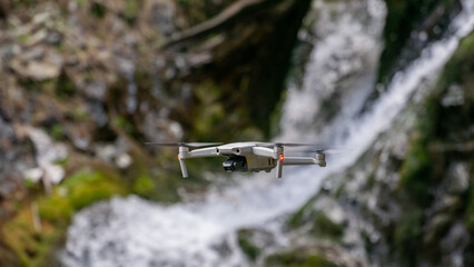 Quadcopter on the background of a waterfall