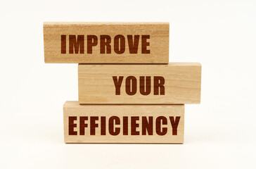 On a white surface are wooden blocks with the inscription - IMPROVE YOUR EFFICIENCY
