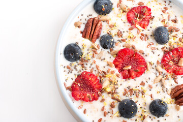 Oatmeal porridge with raspberries and blueberries. Vitamin breakfast